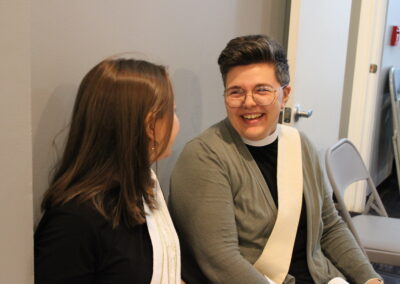 Two clergy members in conversation, smiling