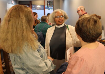 A guest greeting others at the reception