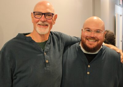 Two guests embracing, smiling